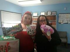 Greter and Barbie showing fun gifts donated for Toy Drive