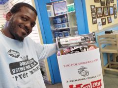 Randolph posing in front of Toys for Tots collection box